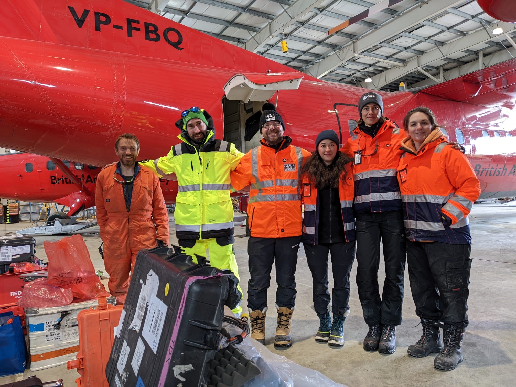 Members of the DEFIANT team posing infront of the Dash-7 aircraft